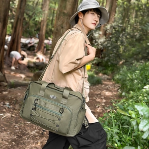 Detail of army green tactical canvas bag with elastic cords and side water bottle pocket