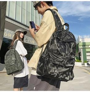 Dual-color camouflage backpacks in black and army green with multiple zip pockets