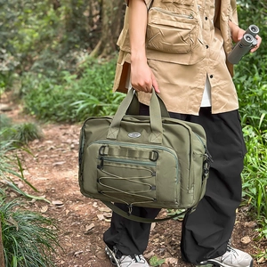 Detail of army green nylon outdoor travel bag featuring multi-compartment and HOCOBAG logo