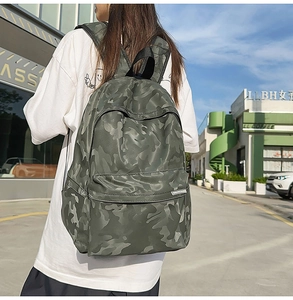 Close-up of green camouflage waterproof backpack showing side straps and durable fabric