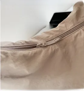 Close-up detail of smooth zipper closure and fabric texture on a canvas tote bag