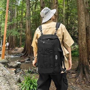 Outdoor forest scene showing model wearing the black high-capacity hiking backpack