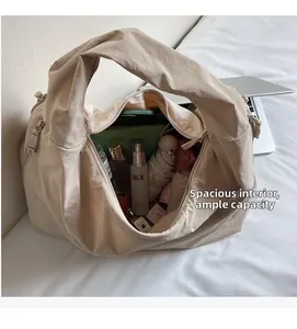 Spacious beige tote bag with pleated texture showing internal storage capacity and daily items