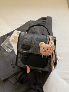 Fashionable dark grey backpack with vintage pattern, bow accent and plush bear charm