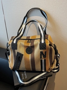 Striped canvas gym tote bag with large N letter patch and adjustable shoulder strap