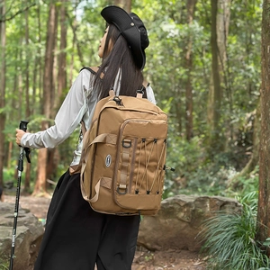 Outdoor earth brown canvas backpack with elastic storage cords and side handle detail
