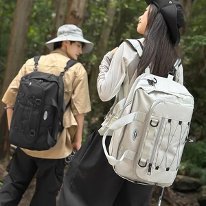 Outdoor backpacks in black and beige shown in forest setting for hiking and travel