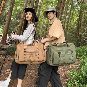 Outdoor lifestyle shot of khaki and army green large canvas travel bags with shoulder straps