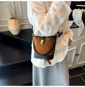Détail du sac seau matelassé marron avec fermoir doré et texture en daim élégante