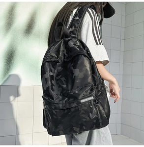 Rear view of a black camo backpack with waterproof matte leather and side pockets