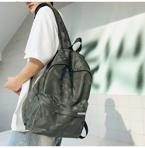 Side view of large camouflage backpack with matte waterproof fabric and wide black straps