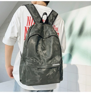 Rear 45-degree view of green camo backpack showing adjustable straps and large capacity