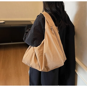 Model view showing the khaki oversized canvas tote bag with side zipper pocket