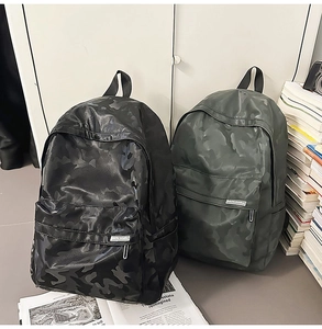 Detail view of camouflage patterns on black and army green minimalist school backpacks