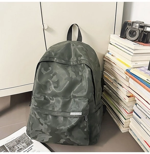 Detail of camouflage backpack with sturdy straps and side pockets in a lifestyle setting