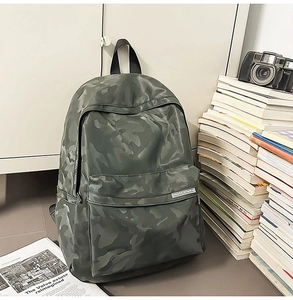 Macro detail of camouflage waterproof backpack with front zipper pocket and camo pattern