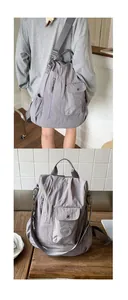 Detail of grey nylon multi-functional backpack showing texture and dual-strap design