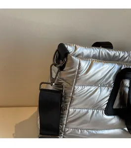 Détail de la ferrure gris fusil et du tissu argenté matelassé sur le grand sac cabas