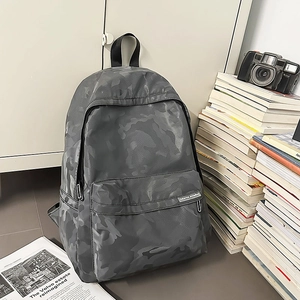 Detail view of water-resistant camouflage backpack with sturdy zipper and fabric texture