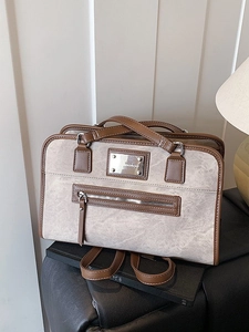 Retro taupe lace-up backpack and tote bag with smooth brown leather trim in soft lighting