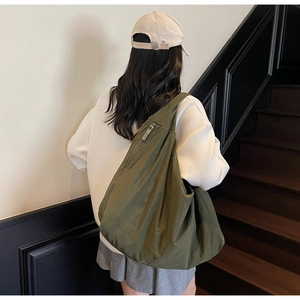 Army green nylon tote bag featuring oversized design with natural crinkle texture details