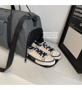 Detail of grey travel bag featuring a specialized side shoe compartment for gym gear