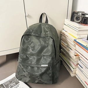 Close-up of camouflage waterproof backpack with front zipper pocket and side mesh pouch