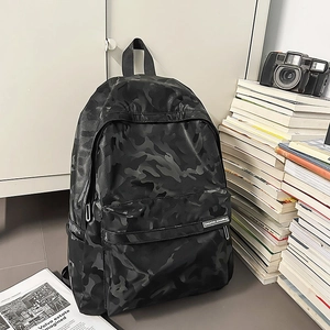 Detail of waterproof black camo backpack with large main compartment and side pocket