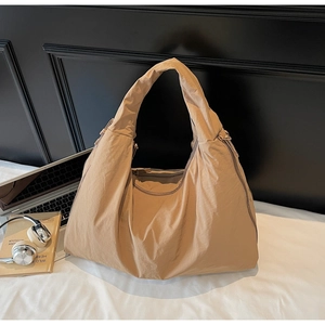 Detail of spacious beige nylon tote bag with zipper closure for daily office commute