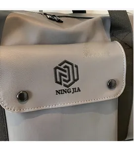Detail shot of a grey fitness bag showing textured fabric and front pocket with buckle closure