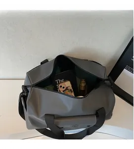 Macro view of gray waterproof travel bag showing open main compartment and storage layout