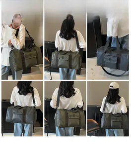 Detail showing an olive green large gym bag with adjustable straps and front pockets
