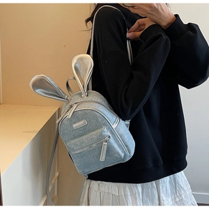 Detail of light blue sequin mini backpack with silver rabbit ears and glitter finish