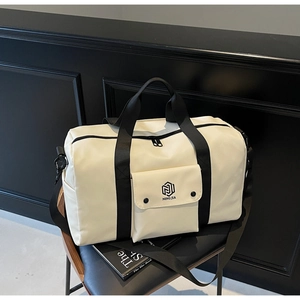 Close-up of beige fitness bag with adjustable black strap and front flap pocket detail