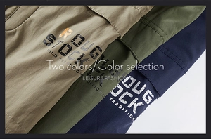 Detail view of khaki, army green and navy blue tactical shorts with retro lettering print