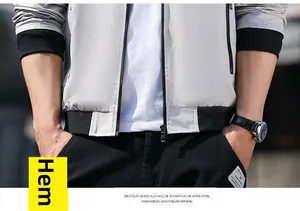 Detail view of the black elastic knitted hem and smooth zipper on a men's baseball jacket