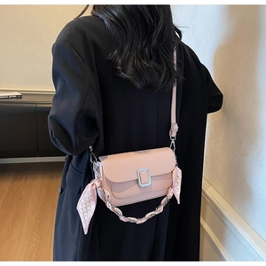 Pink crossbody bag with faux crocodile flap, silk scarf chain detail on female model