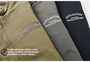 Detail of three heavy cotton jackets in green, grey, and black with printed letter logos