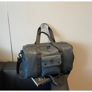 Detail of grey-blue fitness bag featuring waterproof fabric and front flap pocket