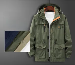 Detail of army green cargo jacket featuring orange lining and durable anti-tear fabric texture