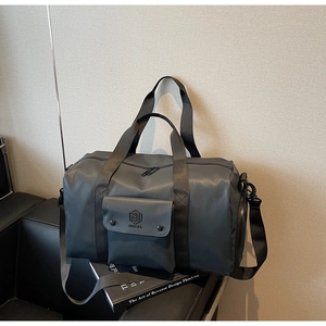 Detail of dark grey gym bag with front storage pocket and adjustable shoulder straps