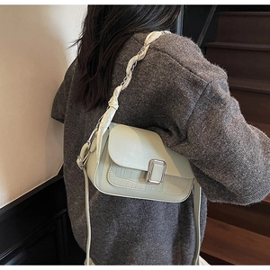 Detail of mint green crossbody bag with silver buckle and silk scarf chain strap