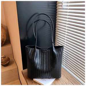 Detailed view of black woven tote bag texture with elegant shadow lighting effects