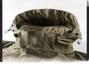 Detail of khaki outdoor jacket featuring windproof high collar and breathable mesh lining