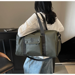 Detail view of large army green fitness bag with front pocket and metal snap buttons