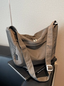Minimalist taupe pleated dumpling bag with large capacity and adjustable wide strap