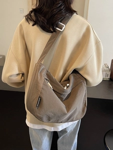 Minimalist large crescent crossbody bag in brown nylon with adjustable strap for daily use