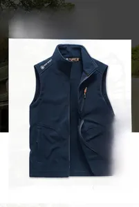 Detail of dark blue fleece vest featuring a stand collar and secure zip pockets