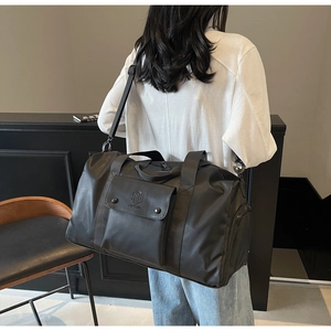 Rear view of a black fitness travel bag with adjustable shoulder strap and large capacity