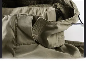 Detail of adjustable Velcro collar with breathable mesh lining on khaki tactical jacket